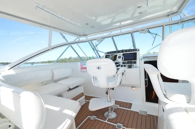 Side Chick Yacht Photos Pics Interior of 2002 Rampage 38 Express boat with white seating and modern controls.