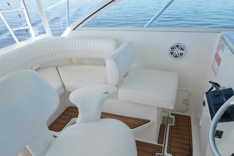 Side Chick Yacht Photos Pics 2002 Rampage 38 Express boat interior with white seating and wooden flooring.