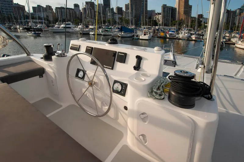 Barefeet Retreat Yacht Photos Pics Helm of 2020 Royal Cape Catamarans Majestic 570 in marina setting.