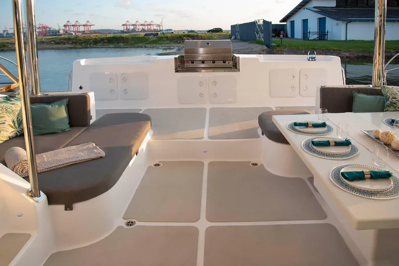 Barefeet Retreat Yacht Photos Pics Luxurious 2020 Royal Cape Catamarans Majestic 570 deck with elegant seating and dining setup.