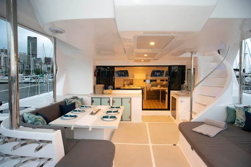 Barefeet Retreat Yacht Photos Pics Luxurious 2020 Royal Cape Catamarans Majestic 570 interior with elegant dining and seating area.