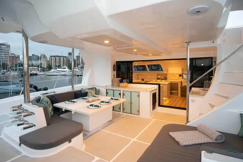 Barefeet Retreat Yacht Photos Pics Luxurious 2020 Royal Cape Catamarans Majestic 570 yacht interior with elegant seating and dining area.