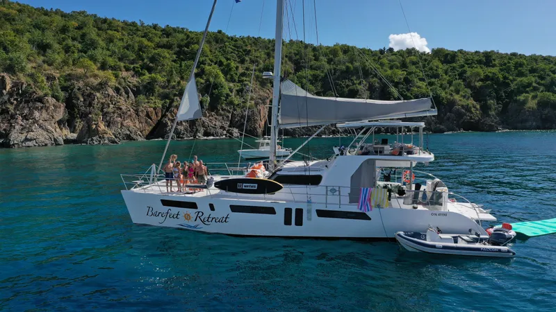 Barefeet Retreat Yacht Photos Pics 2020 Royal Cape Catamarans Majestic 570 sailing in clear waters near lush coastline.