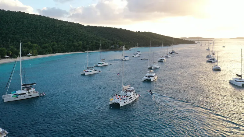 Barefeet Retreat Yacht Photos Pics Aerial view of multiple catamarans, including a 2020 Royal Cape Catamarans Majestic 570, on the ocean.
