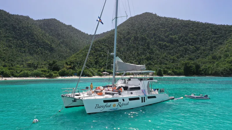 Barefeet Retreat Yacht Photos Pics Royal Cape Catamarans Majestic 570 sailing in turquoise waters near lush green hills, 2020 model.