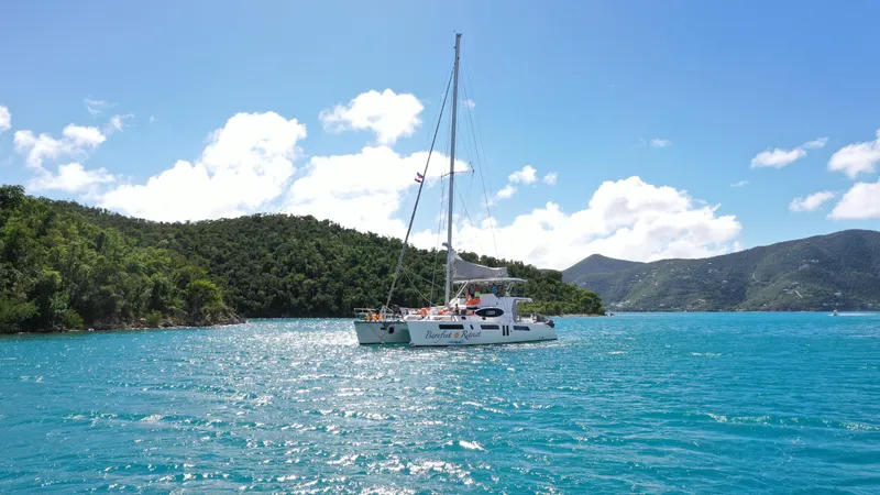 Barefeet Retreat Yacht Photos Pics 2020 Royal Cape Catamarans Majestic 570 sailing in clear blue waters near lush green islands.