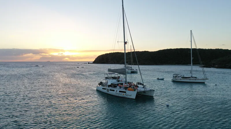 Barefeet Retreat Yacht Photos Pics Royal Cape Catamarans Majestic 570 sailing at sunset near a coastal landscape, 2020 model.