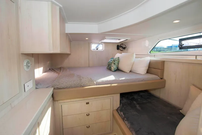 Barefeet Retreat Yacht Photos Pics Luxurious cabin interior of 2020 Royal Cape Catamarans Majestic 570 with cozy bedding.