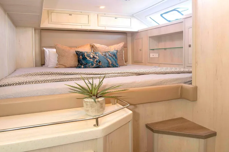 Barefeet Retreat Yacht Photos Pics Luxurious cabin interior of 2020 Royal Cape Catamarans Majestic 570 with elegant bedding and decor.