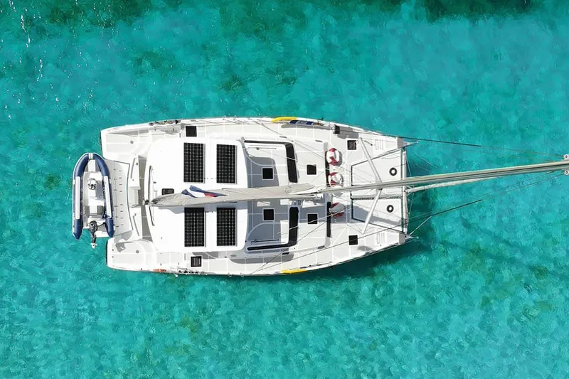 Barefeet Retreat Yacht Photos Pics Aerial view of 2020 Royal Cape Catamarans Majestic 570 on clear turquoise water.