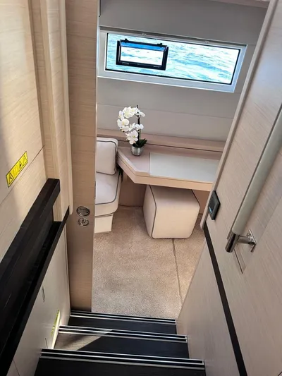  Yacht Photos Pics Interior of 2021 Lagoon 50 yacht, featuring a cozy cabin with a window view.