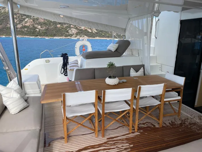  Yacht Photos Pics Outdoor dining area on 2021 Lagoon 50 yacht with ocean view and comfortable seating.