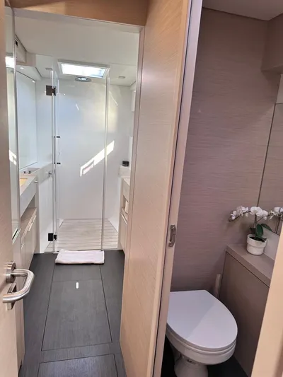  Yacht Photos Pics Modern bathroom interior on 2021 Lagoon 50 yacht, featuring shower and toilet.