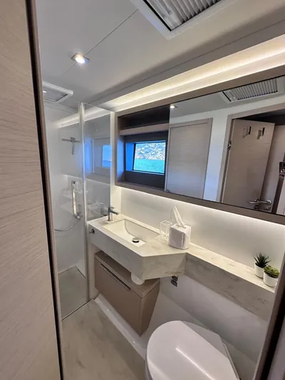  Yacht Photos Pics Modern bathroom interior of 2021 Lagoon 50 yacht with sleek design and natural lighting.