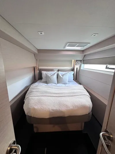  Yacht Photos Pics 2021 Lagoon 50 yacht bedroom with cozy double bed and modern decor.