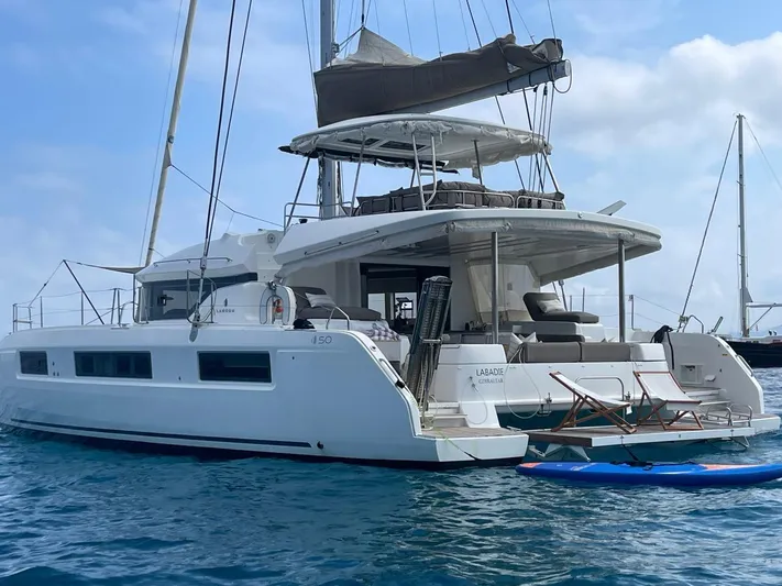  Yacht Photos Pics 2021 Lagoon 50 catamaran anchored in calm blue waters.