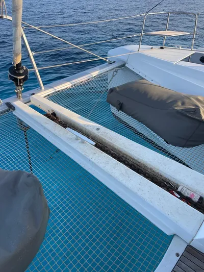  Yacht Photos Pics Lagoon 50 catamaran deck with netting, 2021 model, on calm blue water.