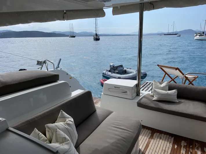  Yacht Photos Pics Luxurious Lagoon 50 yacht deck with comfortable seating, overlooking serene ocean view, 2021 model.