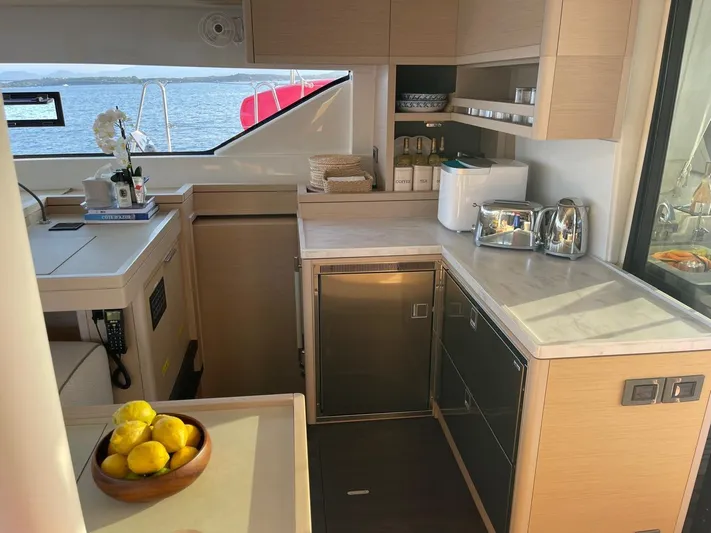  Yacht Photos Pics Modern kitchen interior on 2021 Lagoon 50 yacht with sea view and appliances.