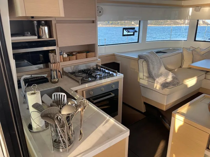  Yacht Photos Pics Interior of 2021 Lagoon 50 yacht with modern kitchen and cozy seating area.