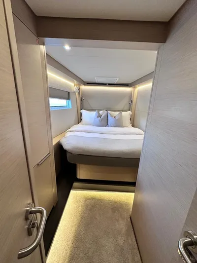  Yacht Photos Pics Luxurious cabin interior of 2021 Lagoon 50 yacht with cozy bed and modern design.