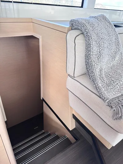  Yacht Photos Pics Interior of 2021 Lagoon 50 yacht with stairs and cozy seating area.