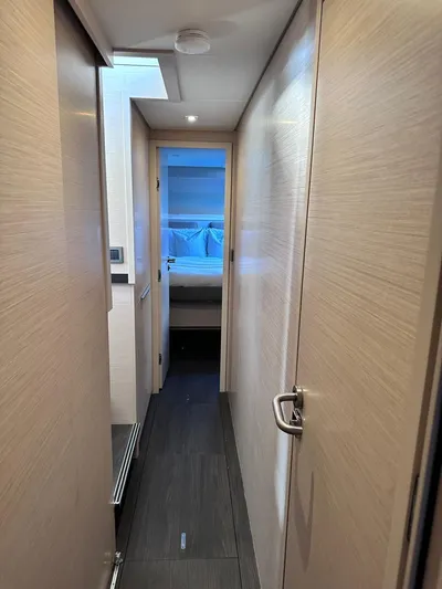 Yacht Photos Pics Interior hallway of 2021 Lagoon 50 yacht, featuring modern design and wood finishes.