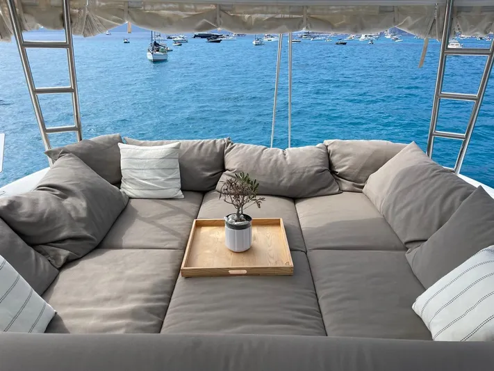  Yacht Photos Pics Luxurious Lagoon 50 yacht lounge area with cushions, tray, and sea view, 2021 model.