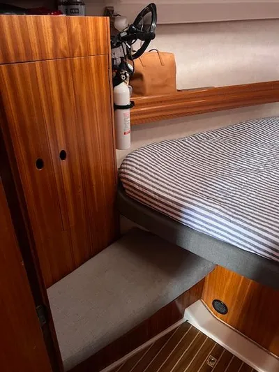 Mockingbird Yacht Photos Pics Cozy cabin interior of 2001 Dufour Gib'Sea 43 sailboat with striped bedding.