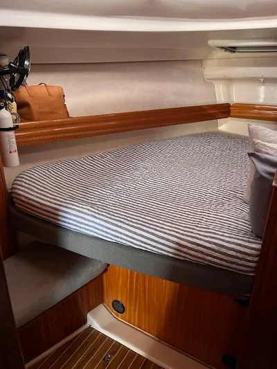 Mockingbird Yacht Photos Pics Cozy cabin interior of 2001 Dufour Gib'Sea 43 sailboat with striped bedding.