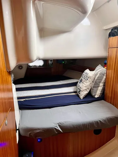 Mockingbird Yacht Photos Pics Cozy cabin interior of 2001 Dufour Gib'Sea 43 sailboat with striped bedding.