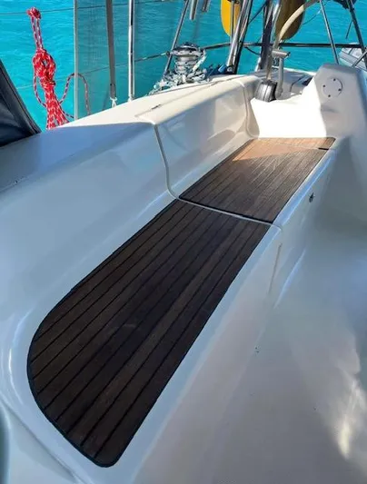 Mockingbird Yacht Photos Pics Dufour Gib'Sea 43 yacht deck with wooden seating, 2001 model, on clear blue water.