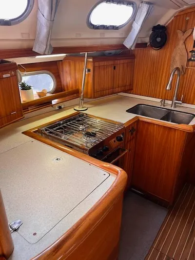 Mockingbird Yacht Photos Pics Interior of 2001 Dufour Gib'Sea 43 yacht kitchen with wood finish and modern amenities.
