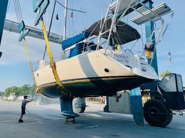 Mockingbird Yacht Photos Pics 2001 Dufour Gib'Sea 43 sailboat being cleaned at a marina lift station.