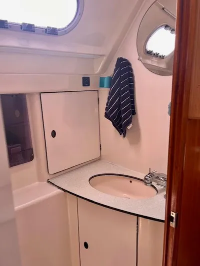 Mockingbird Yacht Photos Pics Bathroom interior of 2001 Dufour Gib'Sea 43 yacht with sink and storage.