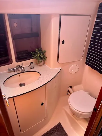 Mockingbird Yacht Photos Pics Bathroom interior of 2001 Dufour Gib'Sea 43 yacht, featuring sink, toilet, and storage.