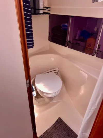 Mockingbird Yacht Photos Pics Bathroom interior of 2001 Dufour Gib'Sea 43 sailboat, featuring toilet and storage cabinets.
