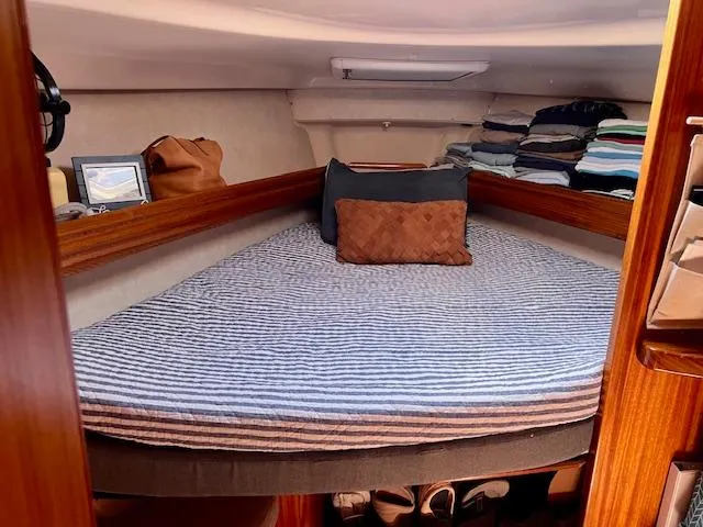 Mockingbird Yacht Photos Pics Cozy cabin interior of 2001 Dufour Gib'Sea 43 sailboat with striped bedding and storage.