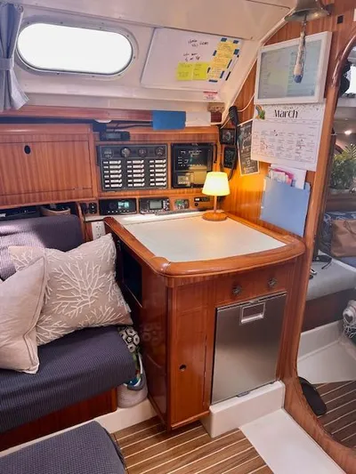 Mockingbird Yacht Photos Pics Interior of 2001 Dufour Gib'Sea 43 yacht with navigation station and cozy seating area.