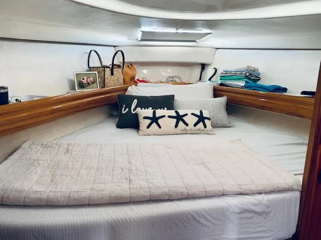Mockingbird Yacht Photos Pics Cozy cabin interior of 2001 Dufour Gib'Sea 43 sailboat with decorative pillows and bedding.