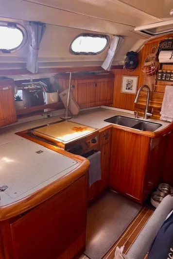 Mockingbird Yacht Photos Pics Interior of 2001 Dufour Gib'Sea 43 yacht kitchen with wooden cabinetry and modern amenities.