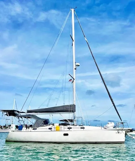 Mockingbird Yacht Photos Pics Sailboat Dufour Gib'Sea 43, 2001 model, anchored on calm water under blue sky.