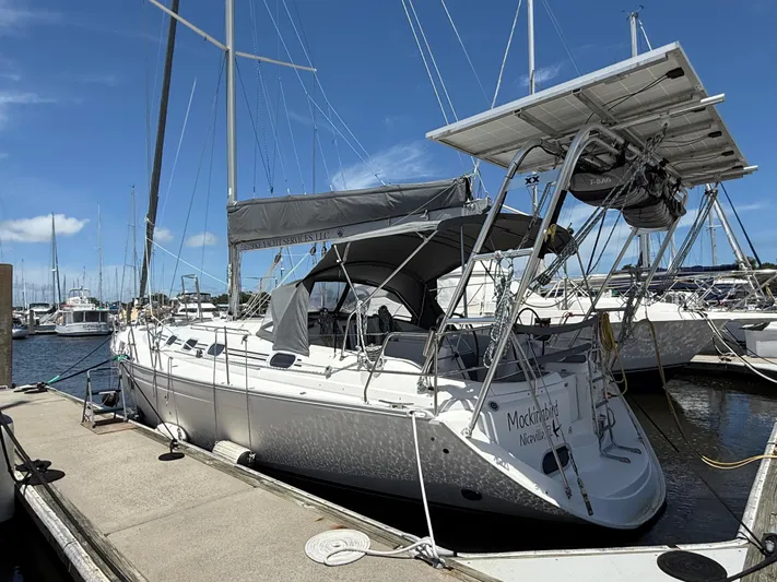 Mockingbird Yacht Photos Pics 2001 Dufour Gib'Sea 43 sailboat docked at marina under clear blue sky.
