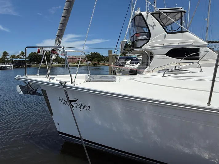 Mockingbird Yacht Photos Pics Sailboat "Mockingbird," Dufour Gib'Sea 43, 2001, docked in a marina under clear skies.
