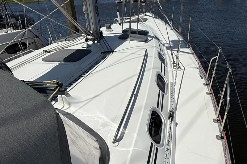 Mockingbird Yacht Photos Pics Deck view of 2001 Dufour Gib'Sea 43 sailboat, featuring sleek design and multiple hatches.