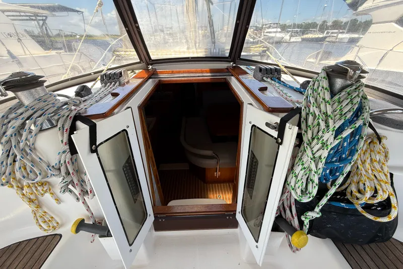 Mockingbird Yacht Photos Pics Cockpit view of 2001 Dufour Gib'Sea 43 sailboat with ropes and open hatch.