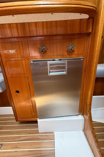 Mockingbird Yacht Photos Pics Wooden interior of 2001 Dufour Gib'Sea 43 yacht with stainless steel appliance.