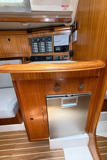 Mockingbird Yacht Photos Pics Interior of 2001 Dufour Gib'Sea 43 yacht with navigation equipment and wooden cabinetry.