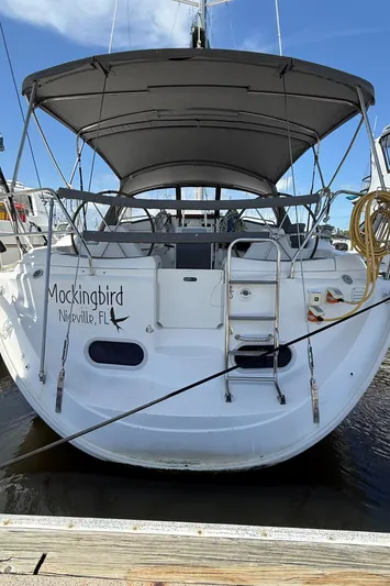 Mockingbird Yacht Photos Pics Dufour Gib'Sea 43 sailboat, 2001 model, docked with canopy and ladder, named "Mockingbird."