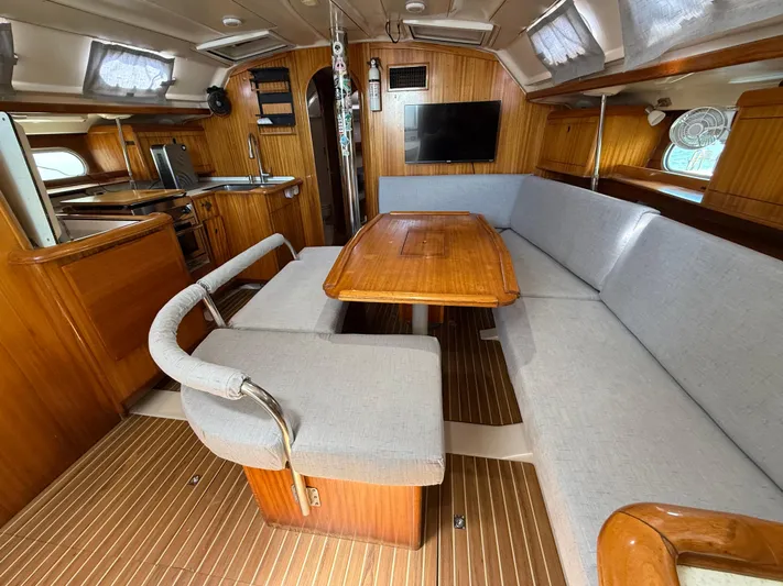Mockingbird Yacht Photos Pics Interior of 2001 Dufour Gib'Sea 43 yacht with wooden furnishings and cozy seating area.